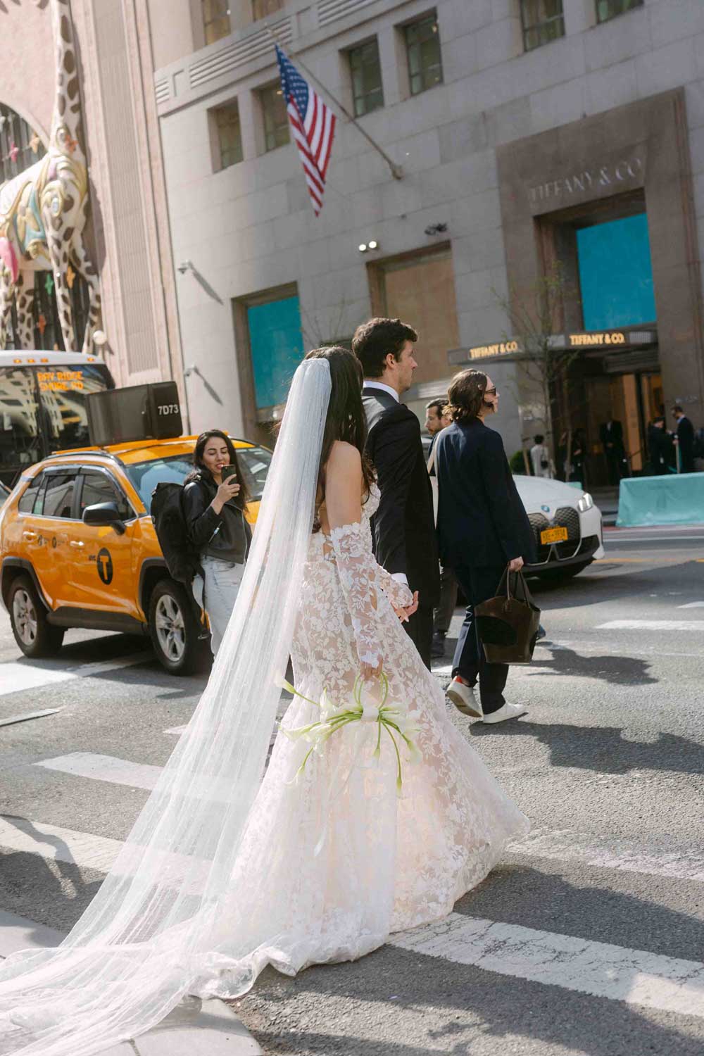 Bride and groom walking editorial style in New York on 5th Street
