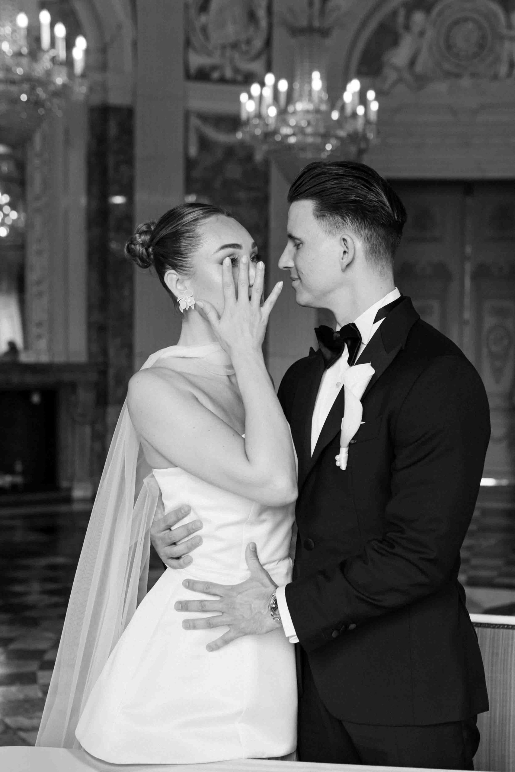Bride shedding a tear at civil wedding ceremony hugged by the groom.