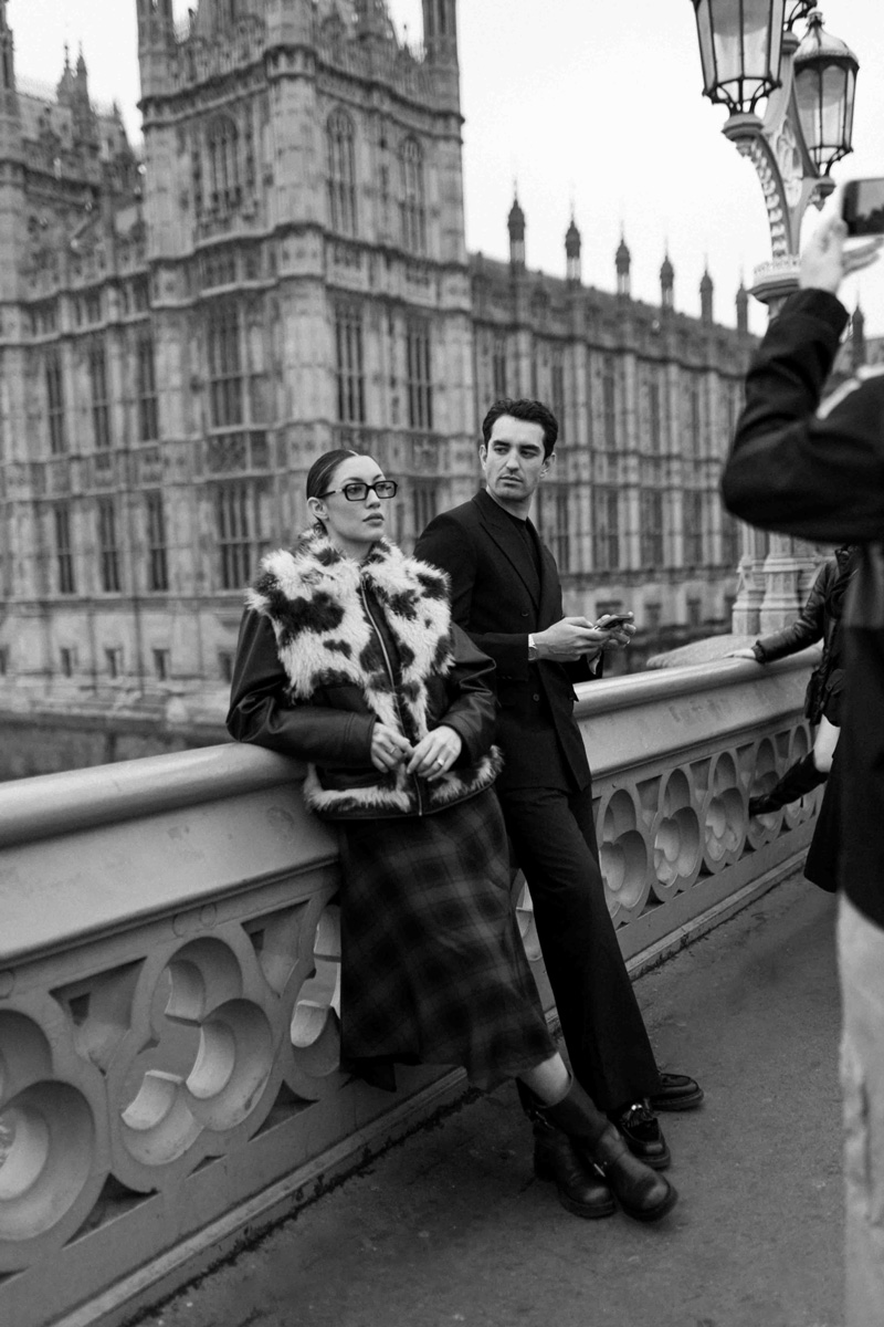 Couple posing on Westminster Bridge in a black-and-white editorial style.