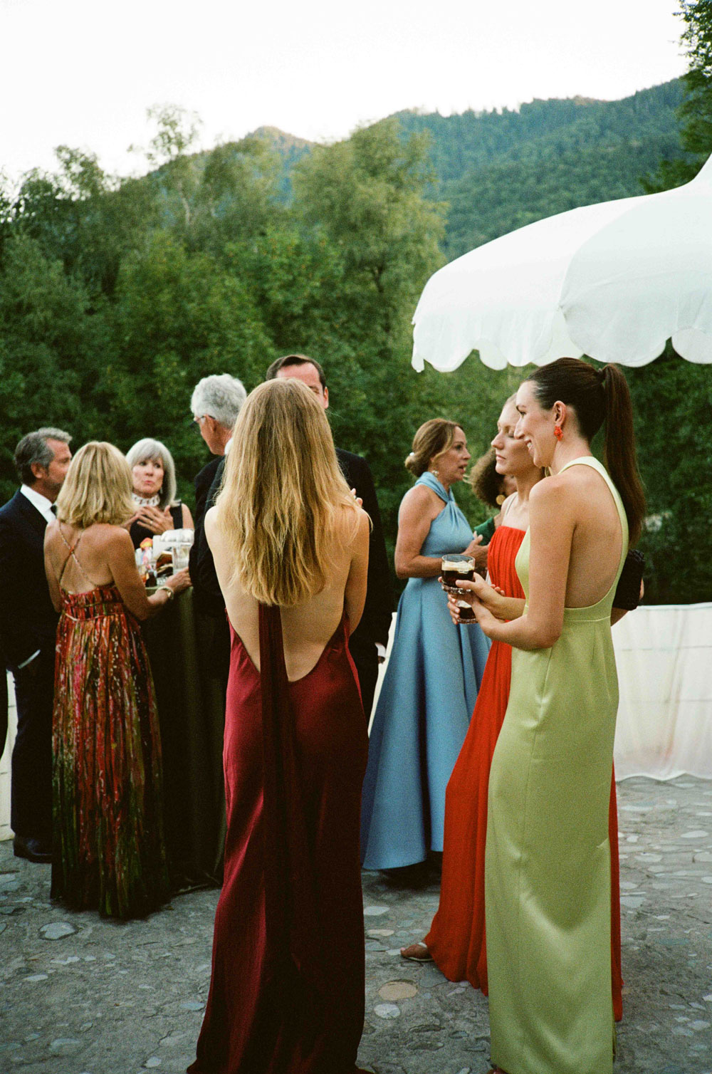 Guests in colourful dresses during the reception, captured on film.